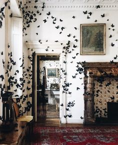 a living room filled with furniture and lots of black butterflies