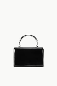 STAUD ARC EVENING BAG BLACK Party Shoulder Bag With Palladium Hardware And Top Handle, Sleek Formal Shoulder Bag With Metal Hardware, Modern Evening Shoulder Bag With Palladium Hardware, Modern Evening Box Bag With Handles, Chic Evening Clutch With Palladium Hardware, Party Shoulder Bag Satchel With Palladium Hardware, Formal Shoulder Bag With Round Handle And Metal Hardware, Formal Shoulder Bag With Metal Hardware And Round Handle, Modern Top Handle Box Bag For Party