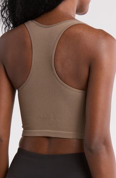 A ribbed texture distinguishes a longline bra with a seamless profile for easy layering whether lounging or heading to the gym. Scoop neck Sleeveless 91% nylon, 9% spandex Machine wash, tumble dry Imported Seamless Medium Support Crop Top For Loungewear, Sports Ribbed Scoop Neck Sports Bra, Seamless Scoop Neck Crop Top For Gym, High Stretch Ribbed Solid Sports Bra, Seamless Compressive Racerback Crop Top, Compressive Racerback Crop Top With Seamless Construction, Ribbed Scoop Neck Sports Bra In Athleisure Style, Athleisure Ribbed Scoop Neck Sports Bra, Seamless Solid Crop Top For Gym