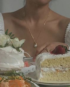 a woman holding a knife and cutting a piece of cake with white frosting on it