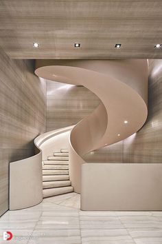 a white spiral staircase in a modern building