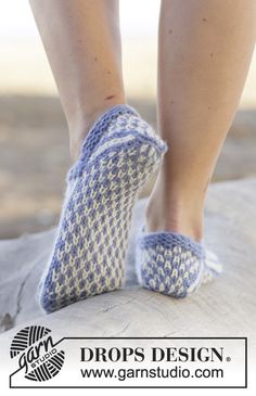 a woman's feet in slippers standing on top of a white object with text that reads drops design