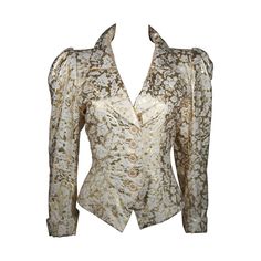 This Yves Saint Laurent jacket is composed of a gold and white fabric with a floral motif. The sleeves feature a puff style with cuff. There are gold with white enamel daisy style buttons at the center front. In excellent vintage condition. Made in France. This YSL evening jacket is from an extensive collection I acquired from the estate of a very wealthy lady who chose to live in Paris for several decades and was determined to spend her entire fortune living luxuriously in a hotel and shopping Saint Laurent Jacket, Floral Print Jacket, Brown Puffer, Vintage Ysl, French Fashion Designers, Evening Jackets, Floral Blazer, Gathered Sleeves, Floral Jacket