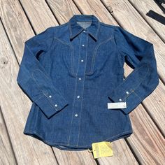 New with tags! Still in excellent condition with no flaws. It's the perfect 70's western snap shirt. Thicker denim feel. Measures 18.5" pit to pit, 26.5" nape to hem, 14.5" shoulder to shoulder and 23.5" shoulder to cuff. Fits like an xs. 70s Western, Vintage 70s, Womens Clothing Tops, Favorite Outfit, Blouses For Women, Size 7, Tops & Tees, Bathing Beauties, Purses And Bags