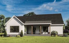 a small white house sitting on top of a lush green field