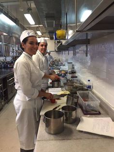 three chefs are in the kitchen preparing food