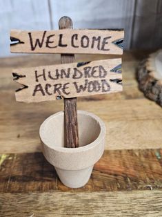 a wooden sign sitting on top of a cup