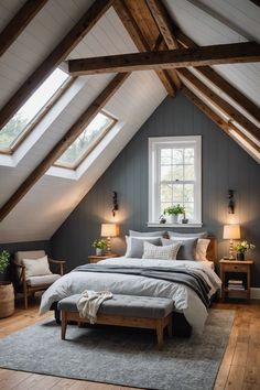 a bed sitting under a window in a bedroom next to a wooden table and chairs