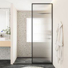 a bathroom with a shower, sink and rug on the floor in front of it