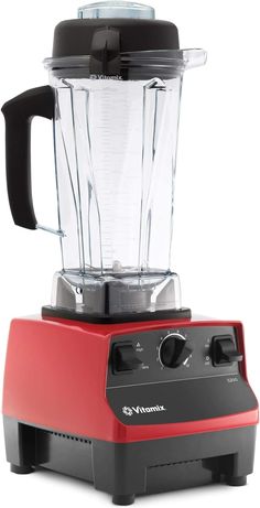 a red blender sitting on top of a white table next to a black lid