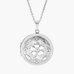 A touch of vintage style, this round locket is crafted from sterling silver and features a floral motif. The perfect keepsake, this locket is strung on a matching cable chain necklace. Engrave the back for a personalized touch. Classic Round Locket Necklace For Keepsake, Elegant Silver Flower Pendant Locket Necklace, Silver Flower Charm Locket Necklace, Elegant Flower Pendant Locket Necklace For Keepsakes, White Round Locket Necklace, Keepsake Flower Charm Locket Necklace, Timeless Silver Locket Necklace, Timeless Silver Engraved Locket Necklace, Silver Locket Necklace With Flower Pendant For Anniversary