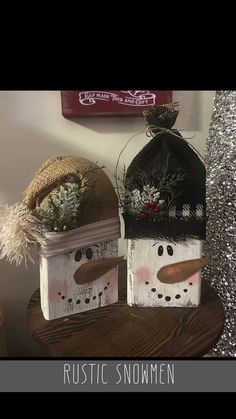 two snowmen are sitting on top of a table