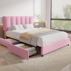 a bed with pink headboard and foot board in a white room next to a window