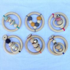 six wooden toys arranged in the shape of rings