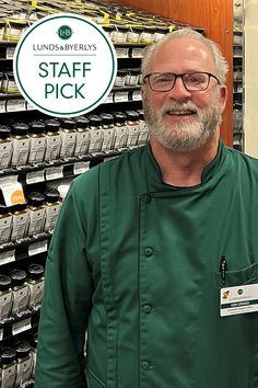 a man standing in front of stacks of cell phones with the words staff pick on it