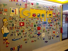 an office cubicle decorated with legos and stickers on the wall that says google