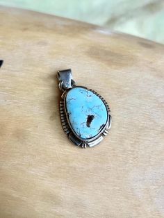 This vintage Small Navajo Sterling silver pendant features a rare high polish Dry Creek turquoise with its symbolic rare pastel blue natural color. Fine and delicate.  Swipe to see picture for pendant measurement, compare to quarter coin. Weight: 4.1 grams Signed: JF Sterling Dry Creek Turquoise comes from a small Turquoise mine outside of Austin, Nevada in Lander County. This mine was previously known for its sky blue to medium blue webbed turquoise. Dry Creek Turquoise has gained much popularity over the years with its creamy pale blue coloring and golden to cocoa brown matrix. This color of Turquoise was rarely used in Turquoise Jewelry before the late 1990s. The color is a pastel blue much like the color of Larimar, only high grade Dry Creek Turquoise has beautiful light brown, golden Bohemian Untreated Oval Turquoise Necklace, Untreated Oval Turquoise Necklace In Bohemian Style, Untreated Bohemian Turquoise Necklace For Collectors, Untreated Southwestern Turquoise Pendant Necklace, Bohemian Untreated Silver Turquoise Necklace, Bohemian Silver Turquoise Necklace, Untreated Turquoise Pendant Necklace Collectible, Untreated Turquoise Pendant Necklace For Collectors, Vintage Untreated Pendant Jewelry