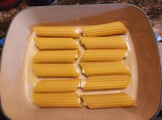 several pieces of uncooked pasta sit in a pan