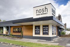 an outside view of a restaurant with nosh food market on the front and side