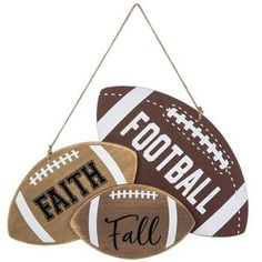 three wooden footballs hanging from a string with the word faith written on each one