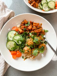 two white plates filled with food on top of a gray table next to each other