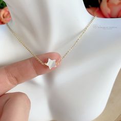 Tiny Mother of Pearl (Nacre) star necklace. The nacre has a high luster with white tones. Celestial jewelry is in at the moment. This is a lovely star necklace, it's a delight for the eyes! This dainty Mother of Pearl star, is made with a gold-plated chain. Perfect for everyday wear, this necklace looks great layered with other necklaces or by itself. When you put on a piece of jewelry, you probably focus on how it looks with your outfit or what it says about your style. Remember, in simplicity, Adjustable 14k Gold Filled Choker As Gift, White Dainty Choker With Clavicle Chain, Dainty White Clavicle Chain Charm Necklaces, Dainty Choker Charm Necklace For Gift, Dainty White Charm Necklace With Clavicle Chain, Delicate Charm Choker Necklace For Gifts, Dainty Gold Necklaces With Star Charm, White Dainty Choker As A Gift, Dainty Necklaces With Star Charm As Gift