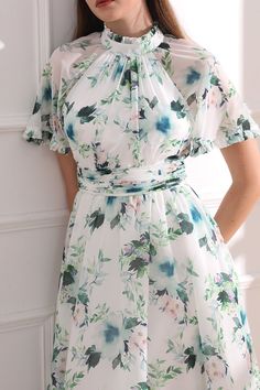 Indulge in the luxurious style of our high neck floral print midi dress. Featuring elegant raglan sleeves and a stunning floral print, this dress exudes sophistication and charm. With a flattering midi length, it will elevate your look for any occasion. Step out in style and turn heads wherever you go. Bust and Skirt with full lining. 100% Polyester 100% Recycled polyester lining Concealed zip at center back Imported Knee-length Floral Print Midi Dress For Garden Party, Spring High Neck Midi Dress, High Neck Midi Dress For Spring, Feminine Floral Print Knee-length Midi Dress, Elegant Short Sleeve Floral Dress For Garden Party, Elegant Floral Print Dress For Brunch, Modest A-line Dress With Floral Print, Elegant Floral Print Knee-length Midi Dress, Fitted Floral Print Dress With High Neck