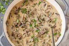 a pan filled with mushroom soup and garnished with parsley