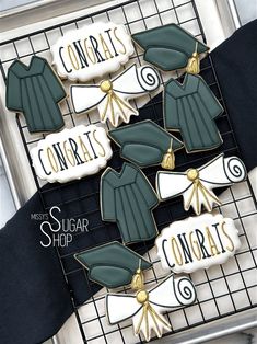 some cookies that are on top of a wire rack with black and white decorations around them