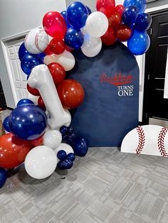 a baseball themed balloon arch with balloons