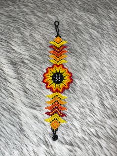 Beautiful Huichol bracelets in the shape of a flower, made with chaquiras by Mexican artisans.the bracelets measure approximately 7.5 to 8 in long Flower Bracelet, Crochet Earrings, Bangles, Crochet, Flowers