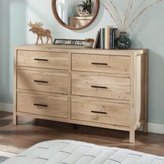 a wooden dresser sitting in front of a mirror