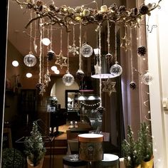 a store window with ornaments hanging from the ceiling