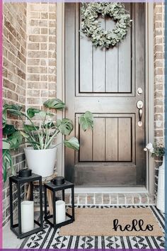 a front door with two candles and a wreath on it