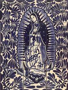 an image of the virgin mary in blue and white tiles