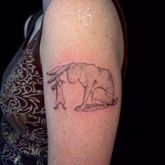 a woman's arm with a tattoo on it that has an image of a dog