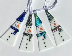 four snowmen are hanging from a string