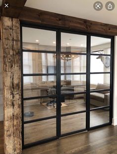 an open living room with sliding glass doors and wood flooring in front of it