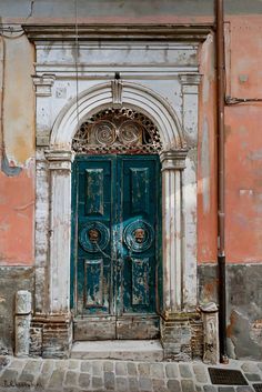 an old building with a large green door