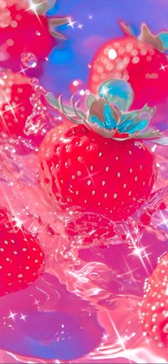 some strawberries are floating in the water and on top of each other with sparkles