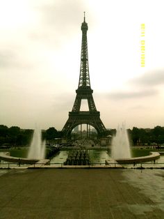 the eiffel tower towering over water fountains