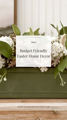 a green planter filled with white flowers and greenery