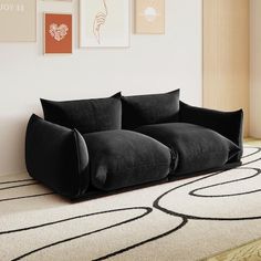 a black couch sitting on top of a white rug