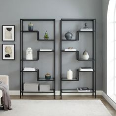 a living room filled with furniture next to a white couch and window in front of a gray wall