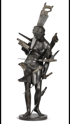 a sculpture of a man holding two swords