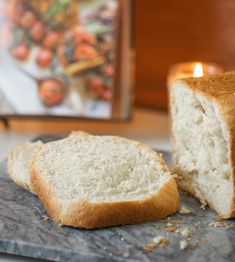 a loaf of bread sitting on top of a counter next to a lit candle