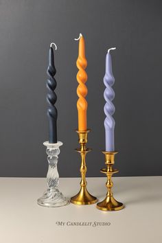 three candles sitting next to each other on a table