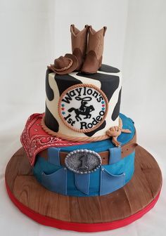 there is a cake that has cowboy boots on the top and booties on the bottom