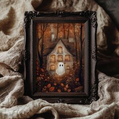 a painting of a house in the woods with a ghost on it's face