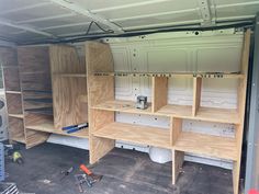 the inside of a van with shelves and tools